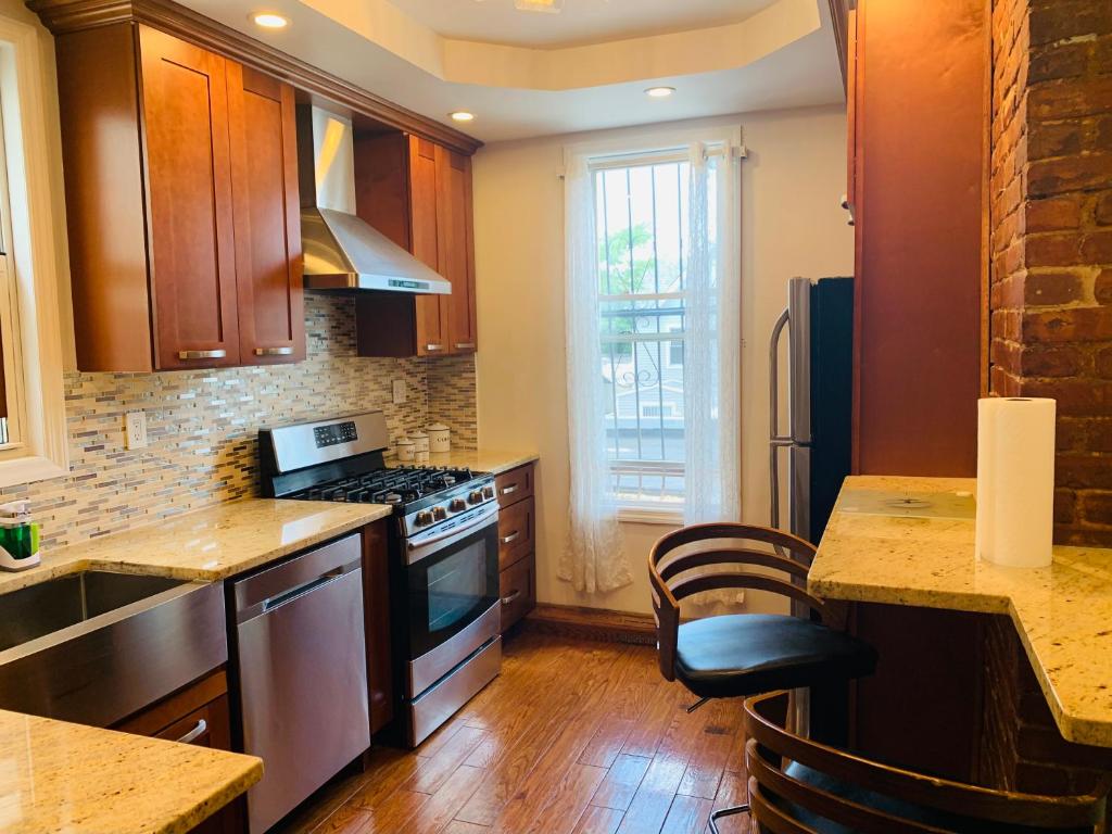 a kitchen with wooden cabinets and a stove top oven at El Edén in Parkchester