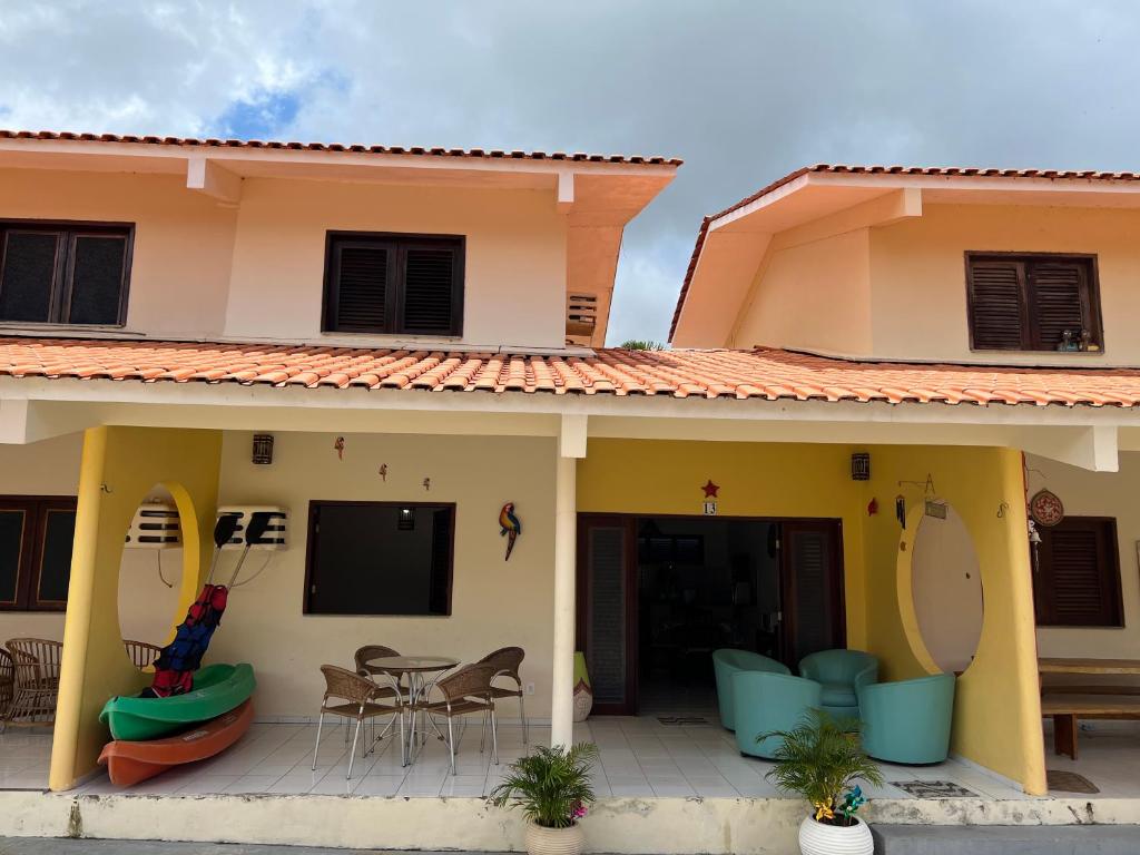 Cette maison dispose d'une terrasse avec une table et des chaises. dans l'établissement CASA DUPLEX em CONDOMÍNIO à beira do RIO PREGUIÇAS, à Barreirinhas