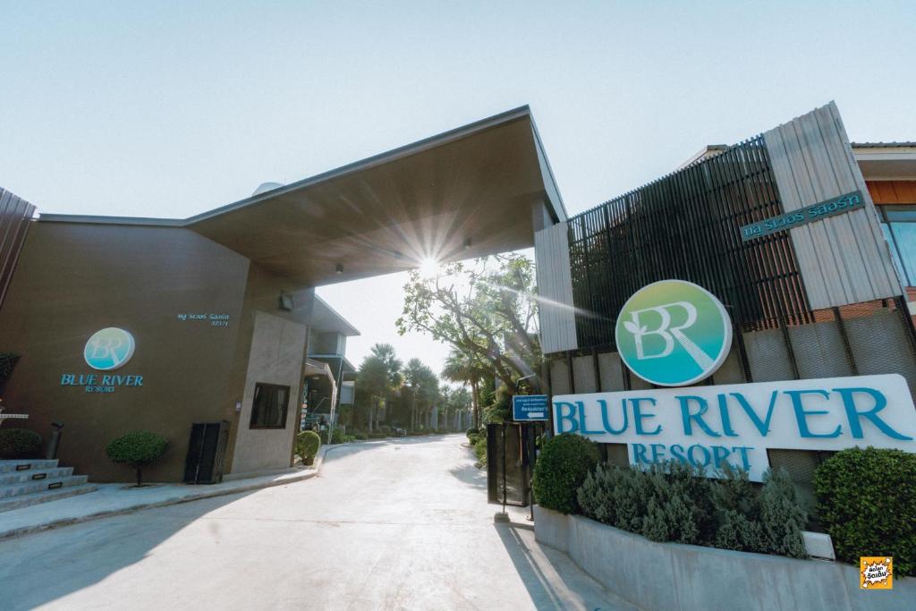 a blue river resort sign in front of a building at Blue River Resort in Phitsanulok