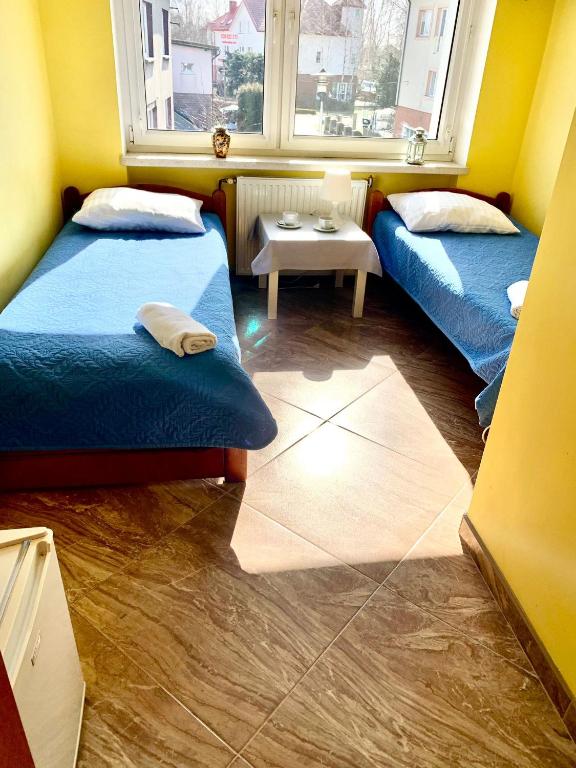 Łóżko lub łóżka w pokoju w obiekcie Willa Morski Kwiat