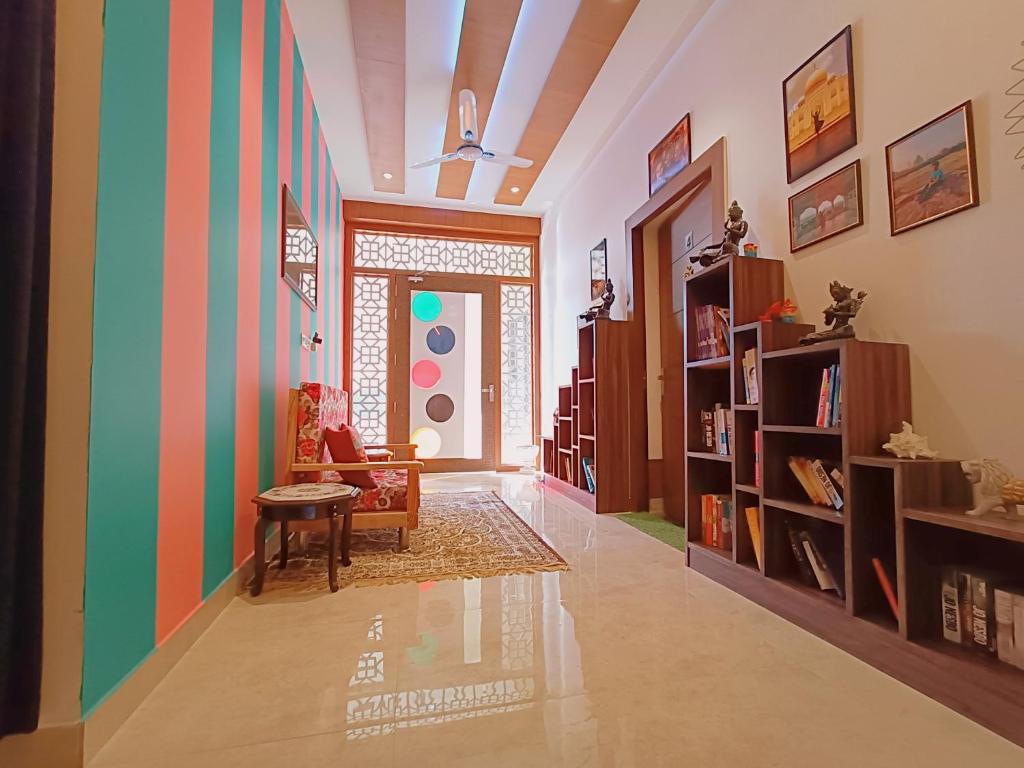 a living room with colorful walls and a table at The Hideout Agra - Garden Homestay near Taj in Agra