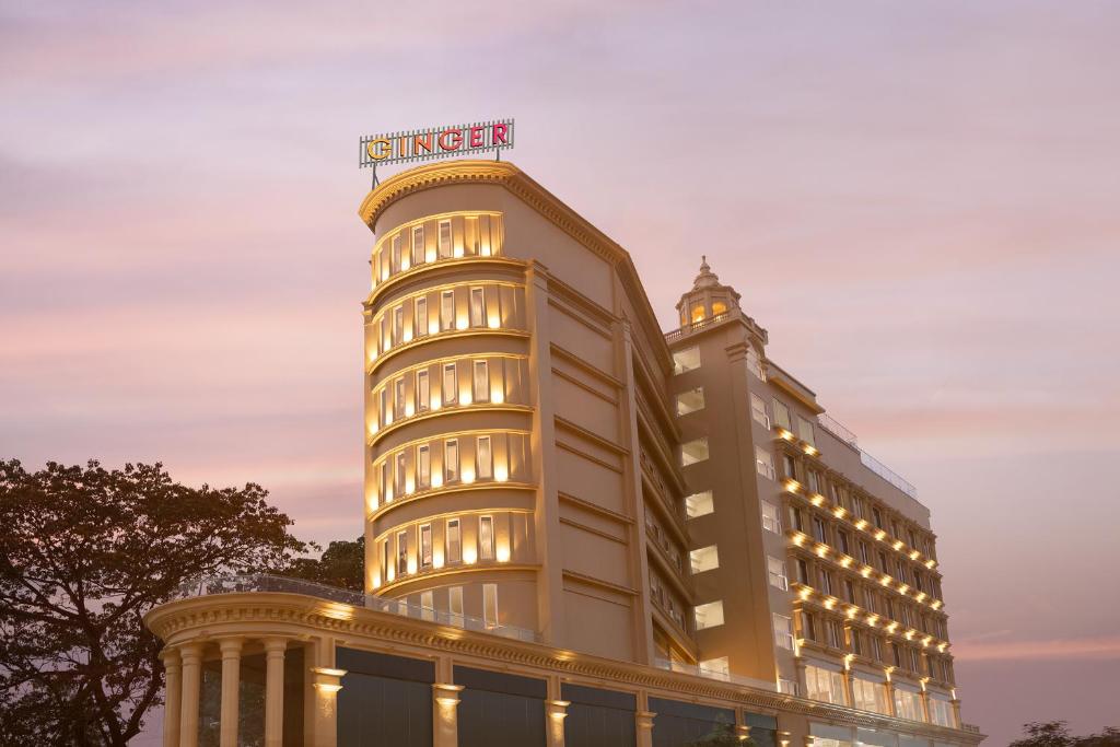 a building with a hotel sign on top of it at Ginger Kochi, Kalamassery in Cochin