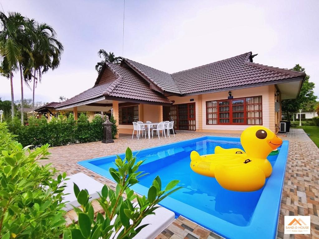 a house with a yellow rubber duck in the swimming pool at Sand-D House Pool Villa C18 at Rock Garden Beach Resort Rayong in Mae Pim