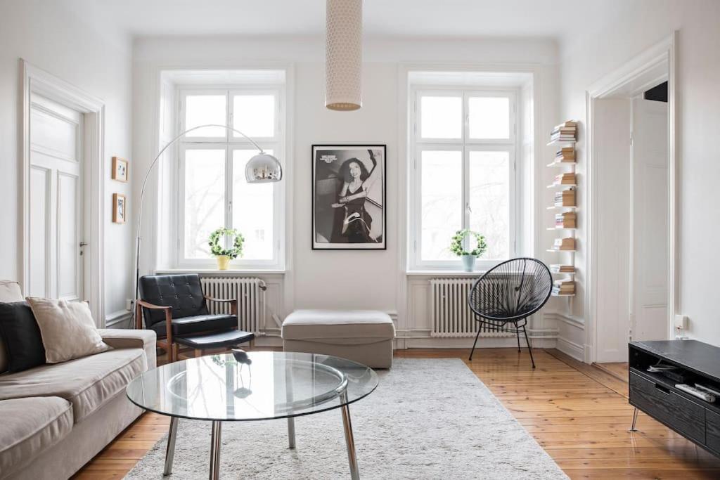 a living room with a couch and a glass table at Exclusive and light 3 room appartment in SoFo 97sqm in Stockholm