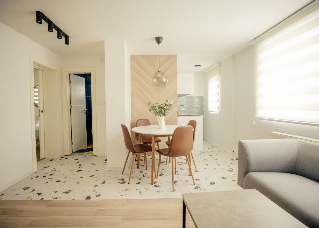 a dining room and living room with a table and chairs at Dusa Zlatibora in Zlatibor