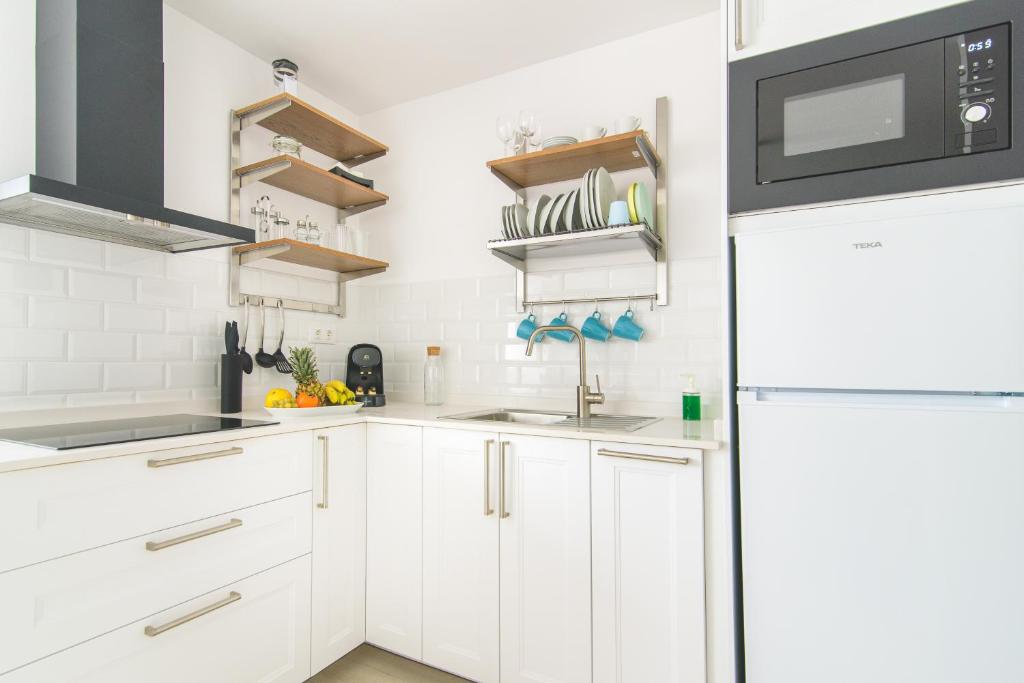A kitchen or kitchenette at Home2Book Stylish Las Canteras3 Beach