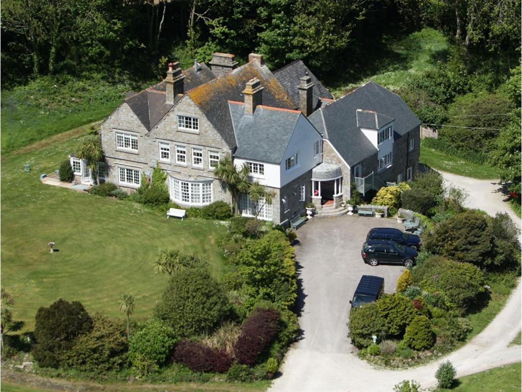 a large house with a car parked in front of it at Higher Faugan Parc in Penzance