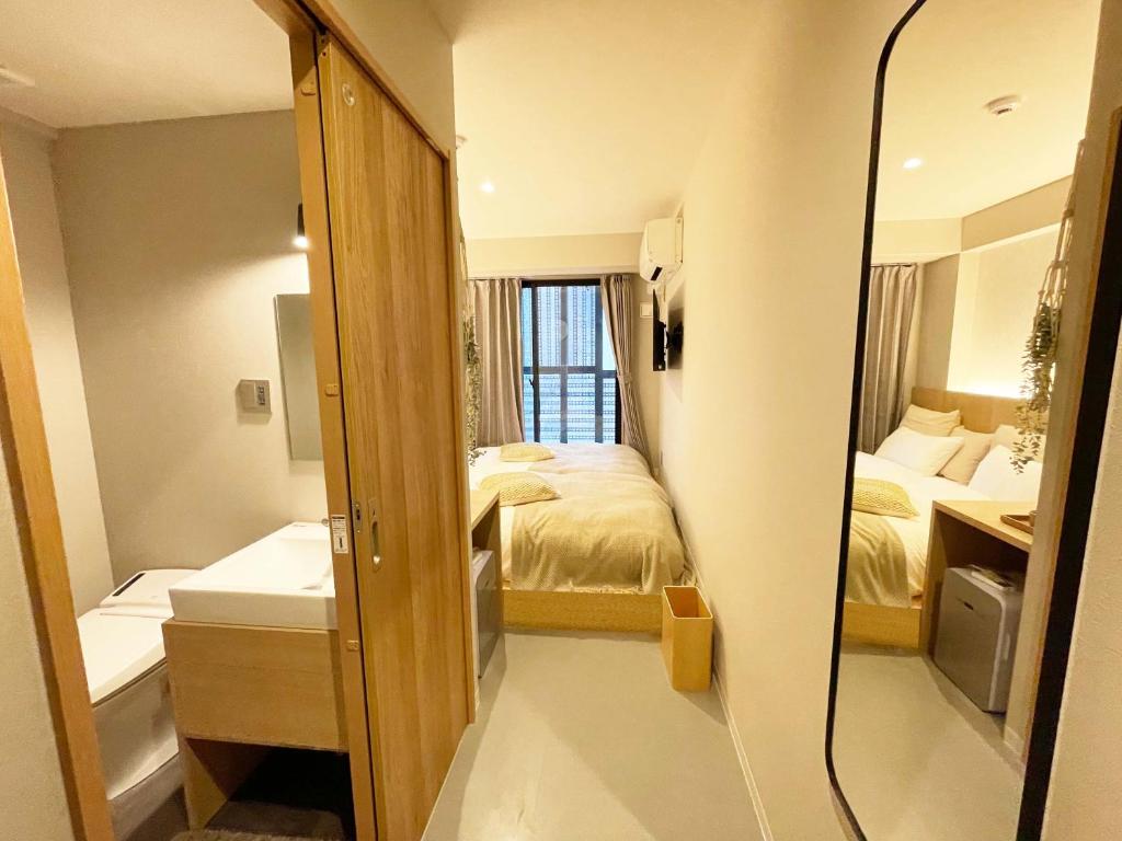 Postel nebo postele na pokoji v ubytování R Hotel Namba