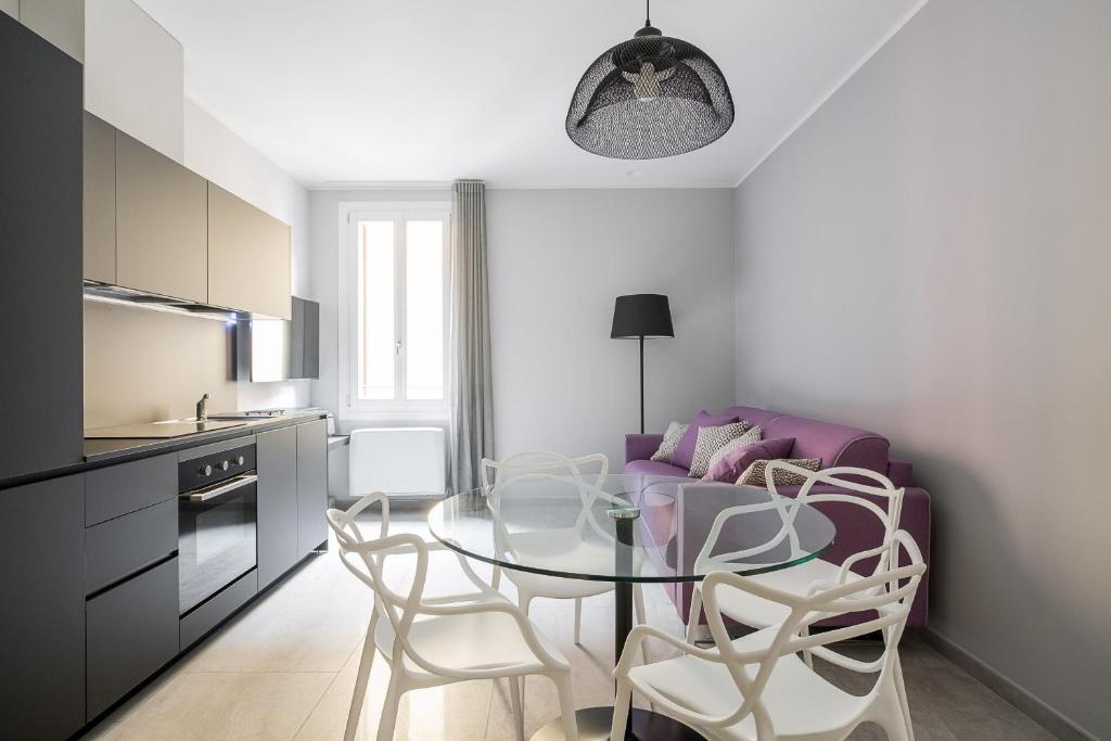 een keuken en een eetkamer met een tafel en stoelen bij Marsala 19 Apartment by Wonderful Italy in Bologna