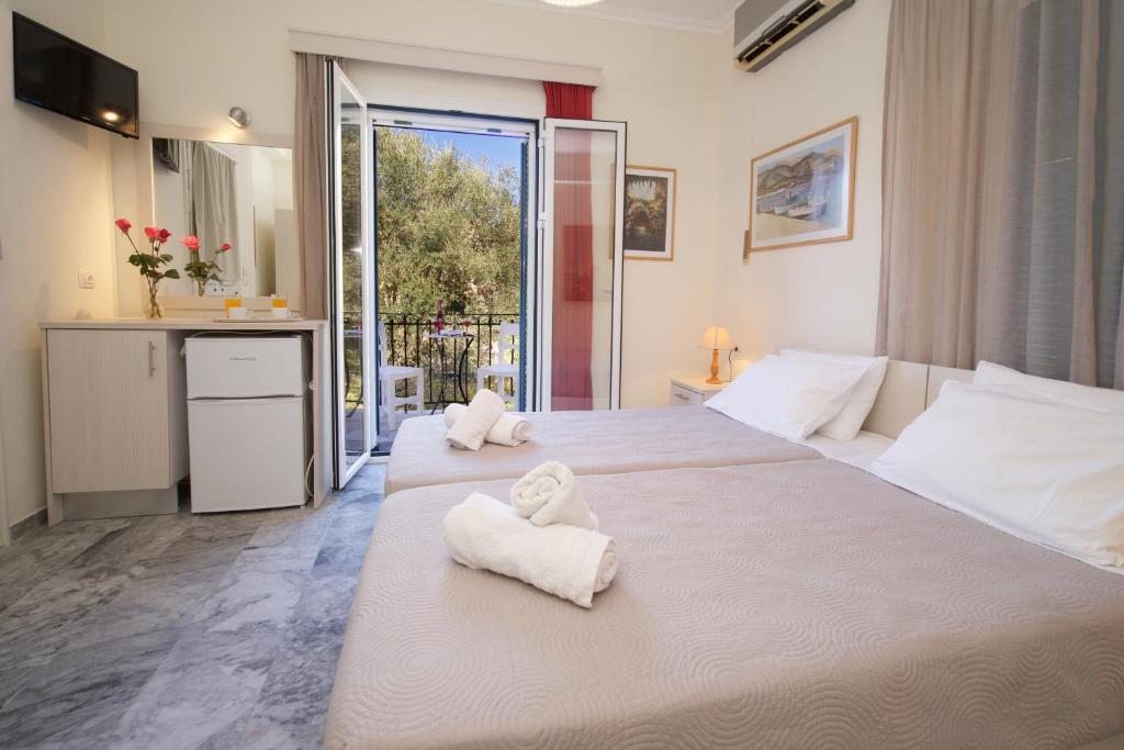 a bedroom with two white towels on a large bed at Prince Studios in Sami
