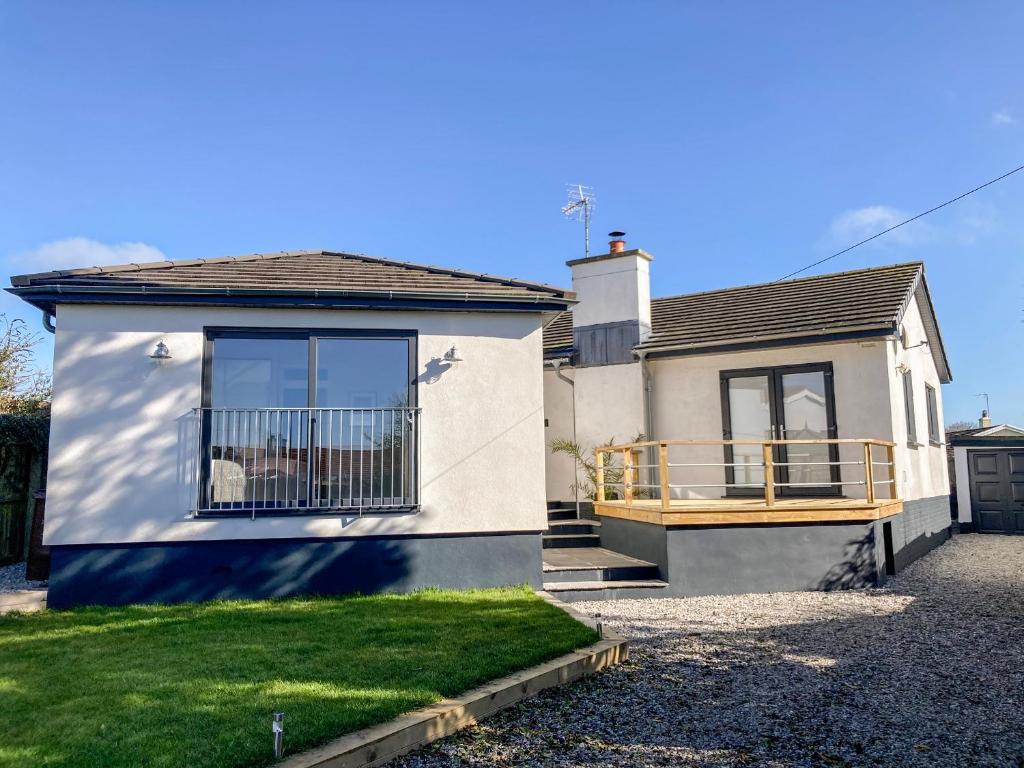 a house with a deck on the side of it at 38 Venn Park in Stoke Fleming