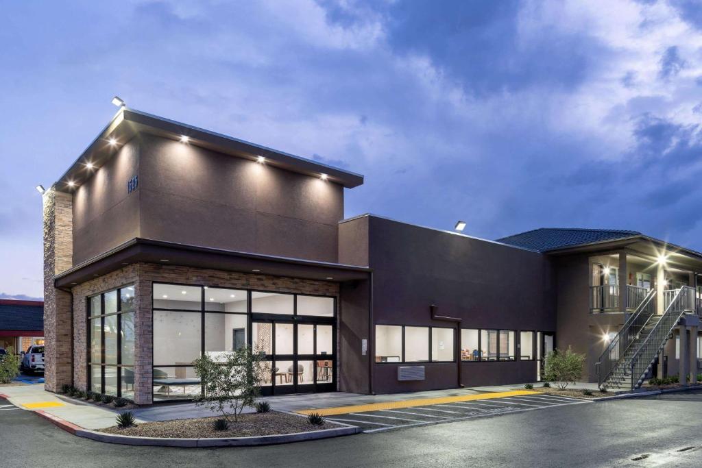 a black building with a staircase in a parking lot at Ramada by Wyndham Modesto Yosemite Area in Modesto