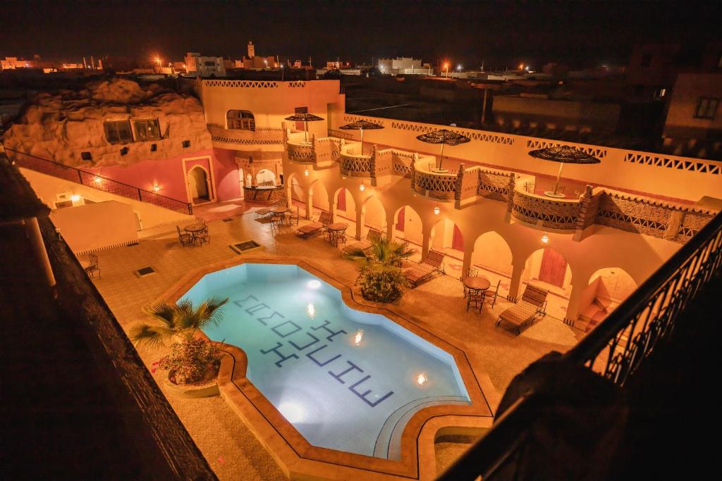 an overhead view of a swimming pool at night at Riad Mamouche in Merzouga
