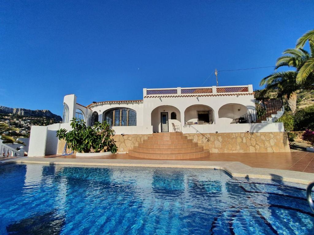 a house with a swimming pool in front of a house at Casa Sueño in Calpe