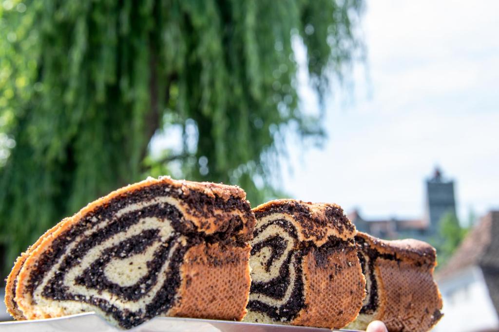 a person holding a piece of cake with the number two at Pension Mama Cozonacilor in Bran