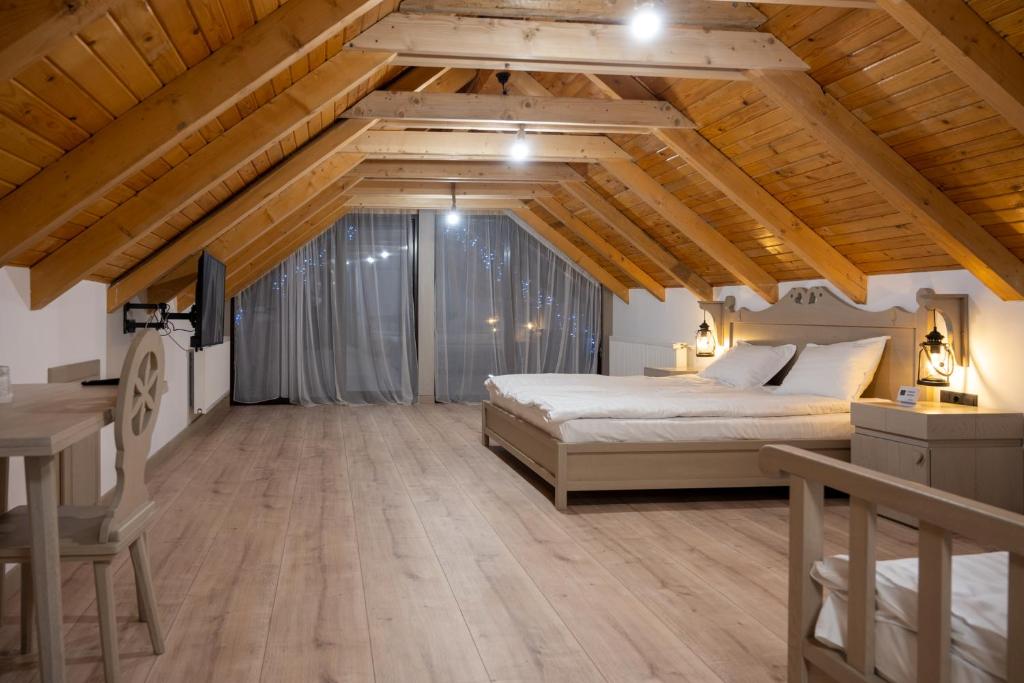a bedroom with a bed and a desk in a room at Pension Mama Cozonacilor in Bran