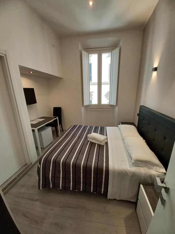 Postel nebo postele na pokoji v ubytování Hotel Mimosa Pantheon