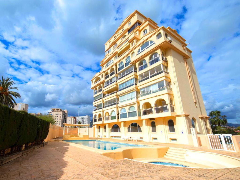 a large building with a pool in front of it at Apartment Saladar-1 by Interhome in Calpe