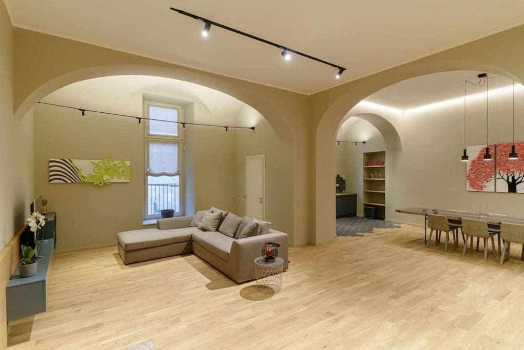 a large living room with a couch and a table at Crociferi Luxury Apartment in Catania