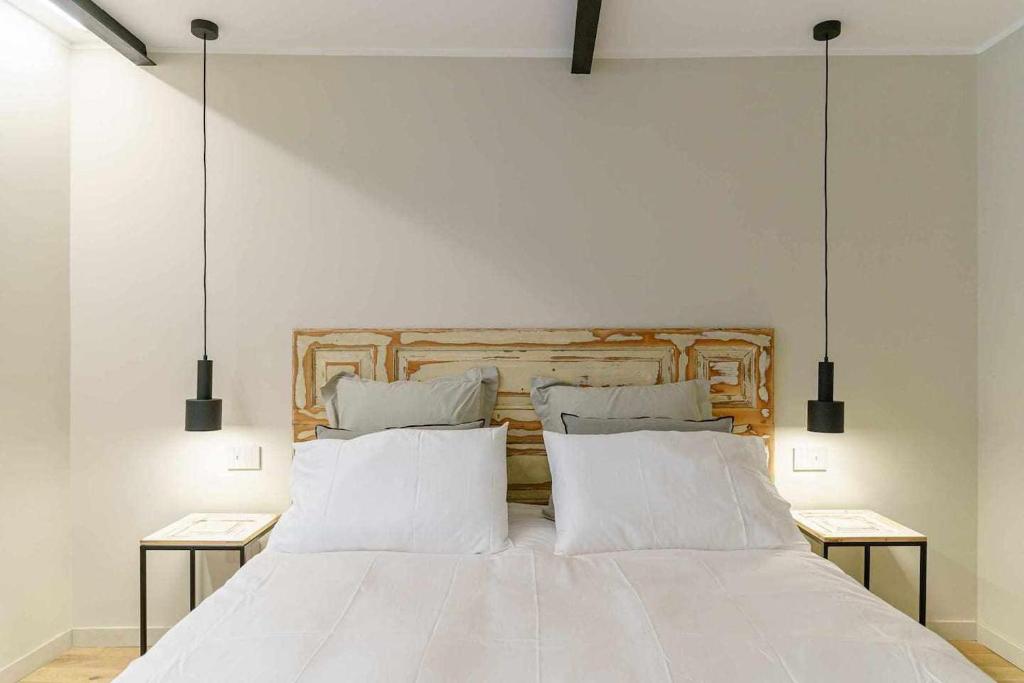 Łóżko lub łóżka w pokoju w obiekcie Crociferi Luxury Apartment