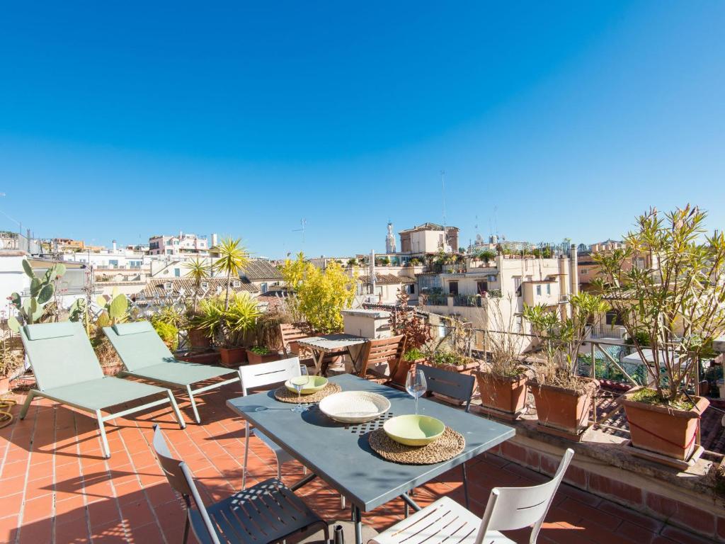 a patio with a table and chairs on a roof at Apartment Terrazza a Piazza di Spagna by Interhome in Rome