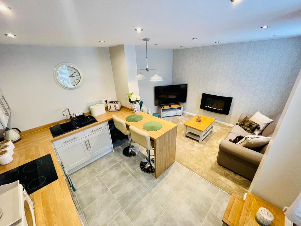 a kitchen and living room with a table and a couch at The Old Piggery - Close to Lytham, Preston & Blackpool in Freckleton