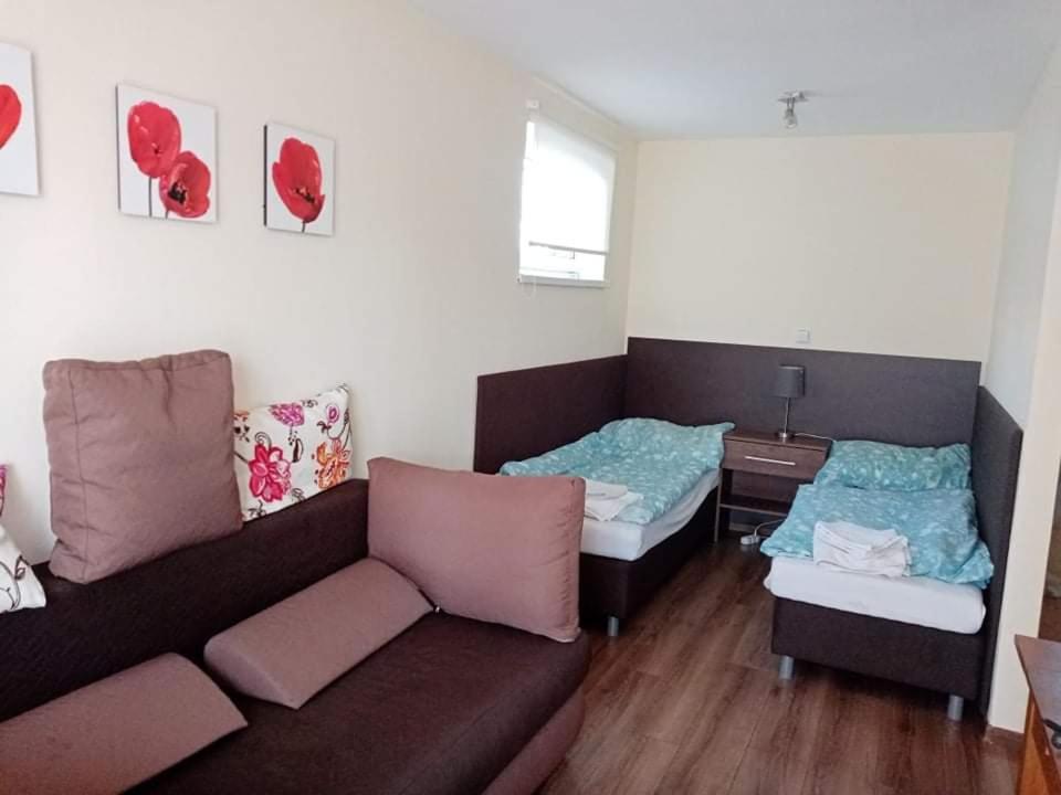 a living room with two beds and a couch at Chatka Tatry in Veľký Slavkov