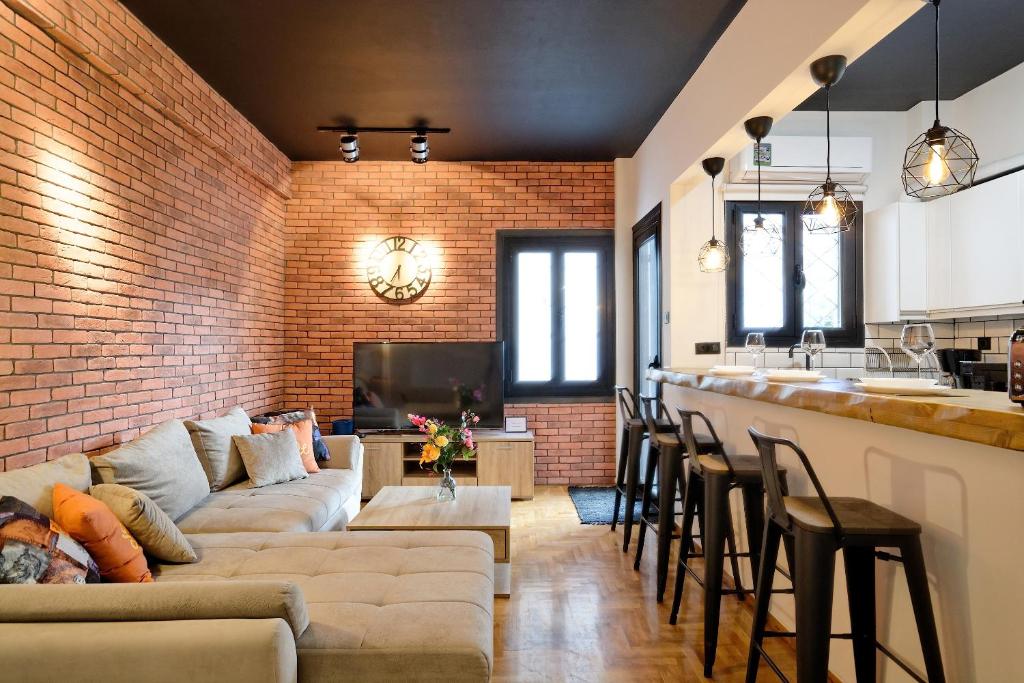 a living room with a brick wall and a bar at Glyfada Breeze Apartments in Athens