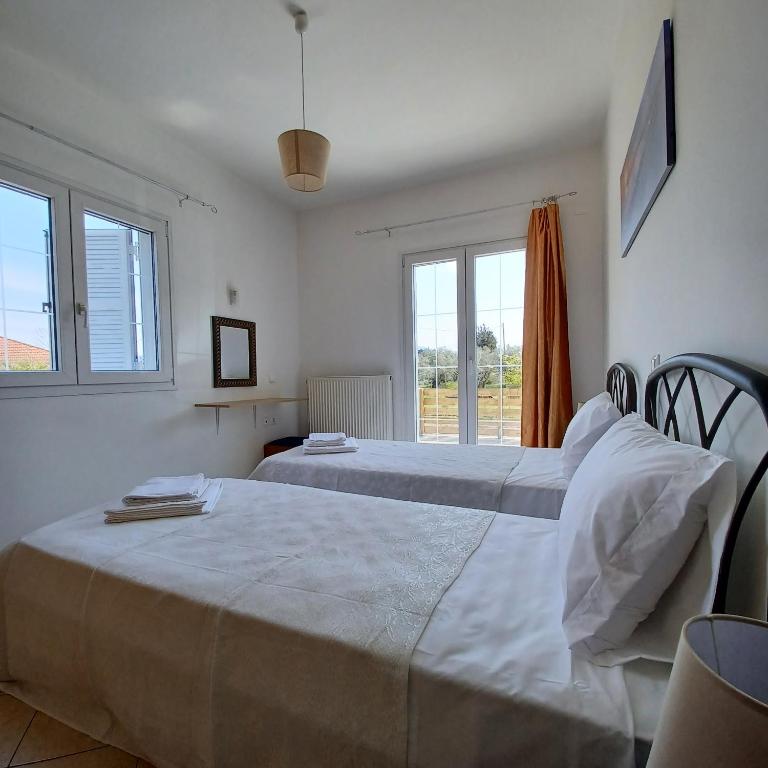Postel nebo postele na pokoji v ubytování Eleonas Apartment 1, Lygia