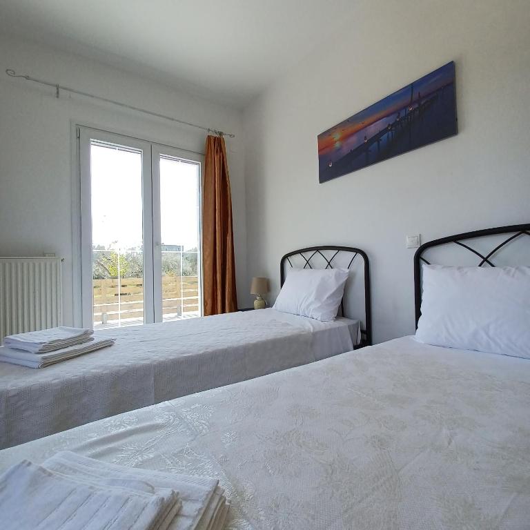 Postel nebo postele na pokoji v ubytování Eleonas Apartment 1, Lygia