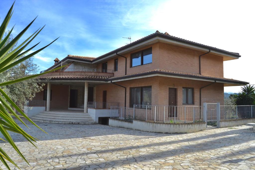 a brick house with a palm tree in front of it at Ninfea B&B in San Giovanni Teatino