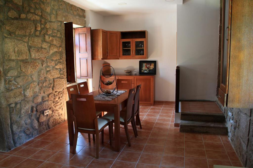 a kitchen and dining room with a table and chairs at Albergue e AL O Brasão Valença in Valença