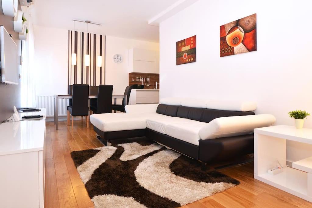 sala de estar con sofá blanco y negro en Apartment Trnje, en Zagreb