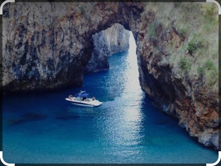 a boat in a cave in the middle of the water at IsolaDino b&b sweet home in Praia a Mare