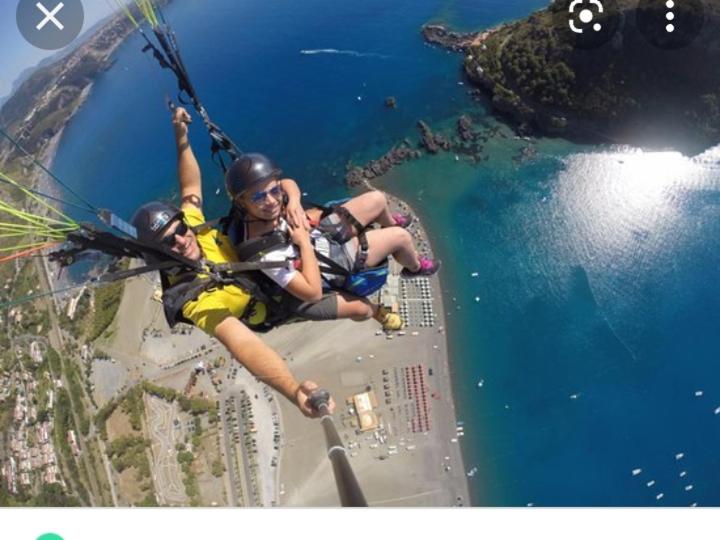 two people are on a zip line over the water at IsolaDino b&b sweet home in Praia a Mare