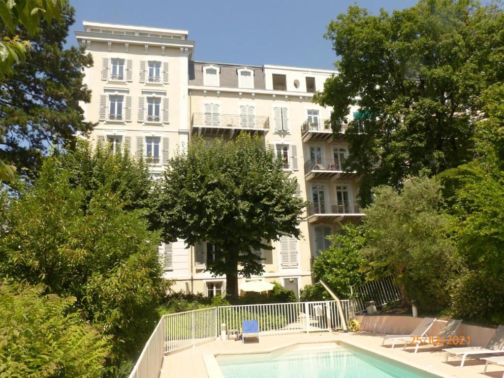 a building with a swimming pool in front of a building at Suite 22 in Aix-les-Bains