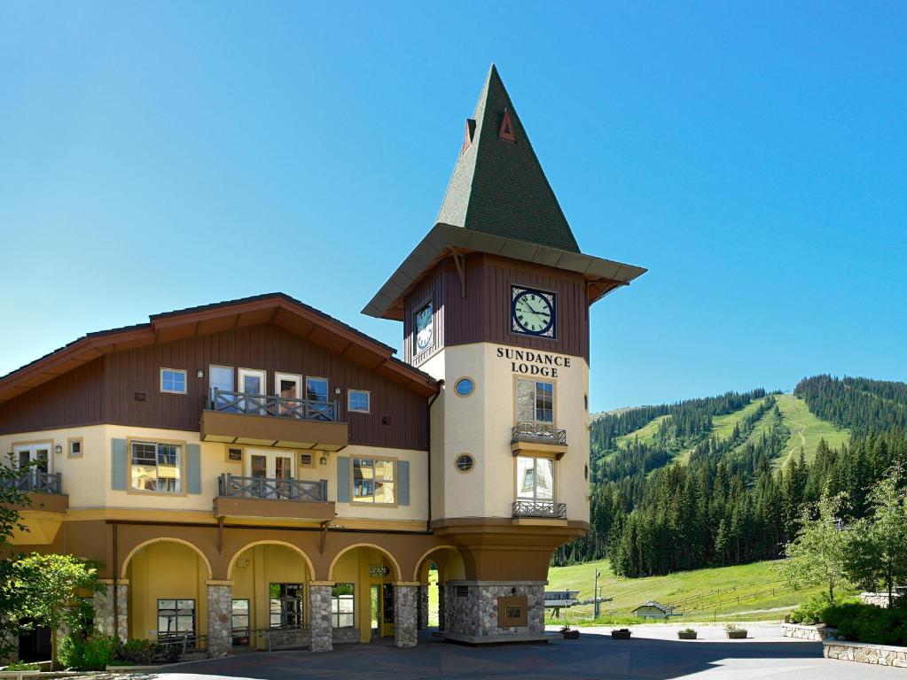 
a large building with a clock tower on top of it at Coast Sundance Lodge in Sun Peaks
