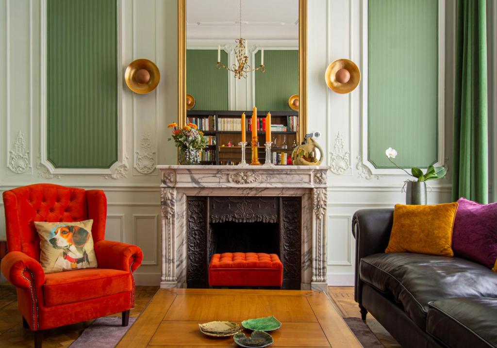 a living room with a red chair and a fireplace at The Old Beech in Antwerp