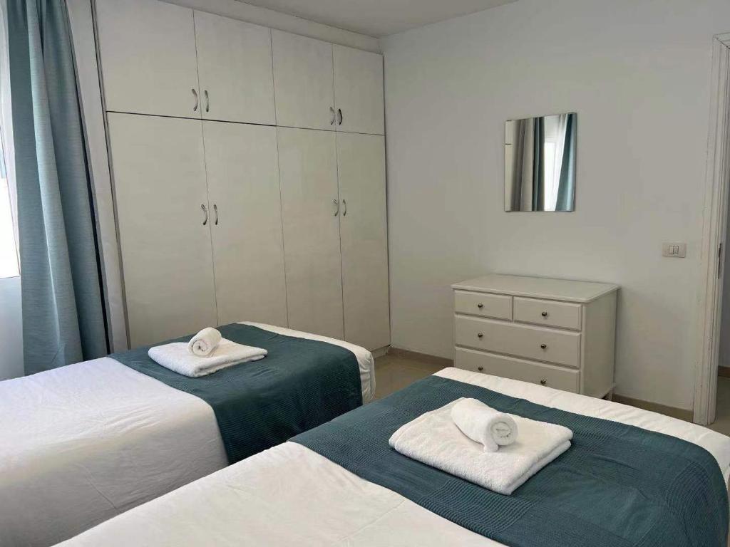A bed or beds in a room at Apartamento Olivin