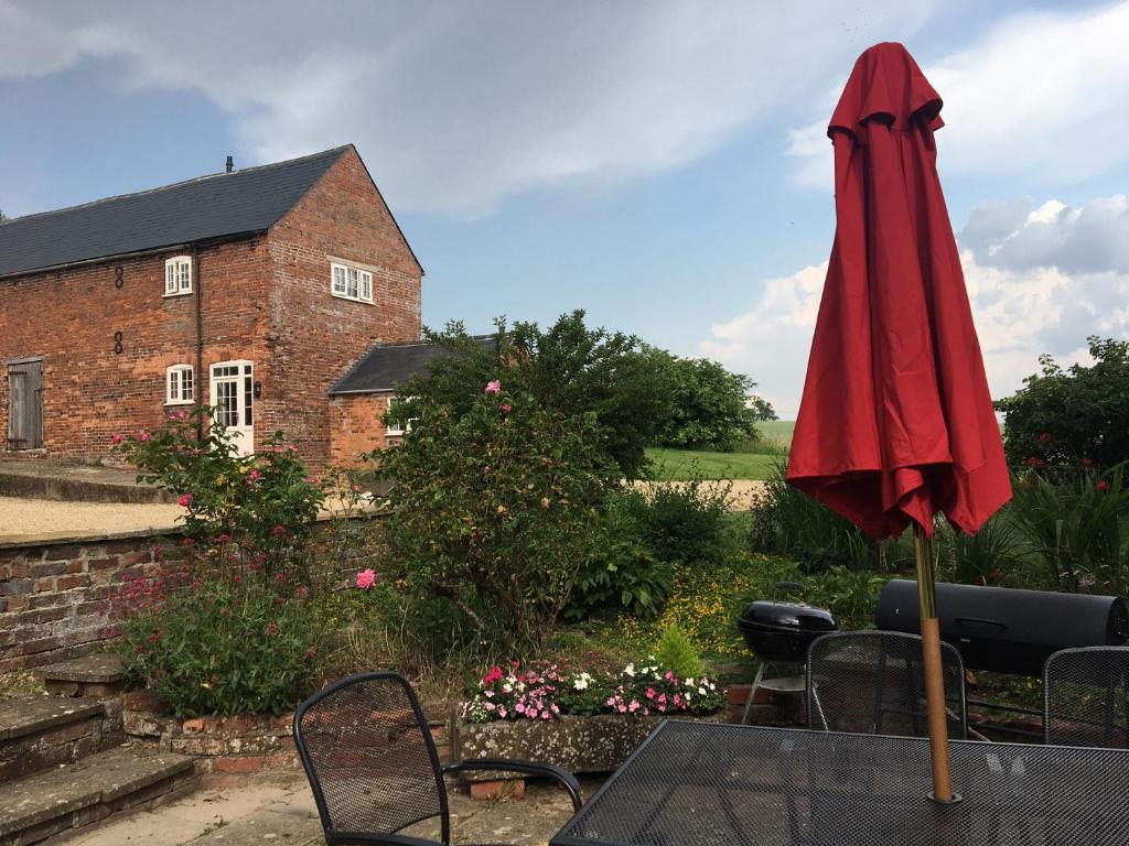 a red umbrella sitting on top of a table at Cosy getaway near Rutland Water in Oakham