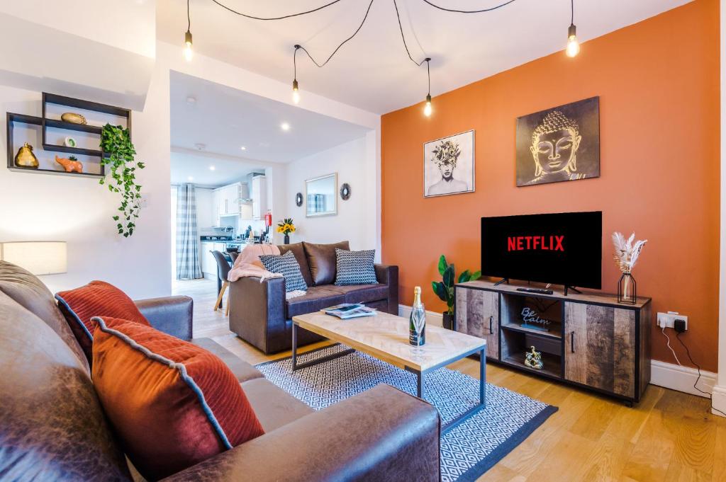 a living room with a couch and a tv at Pristine 2-bed house in Chester by 53 Degrees Property, ideal for Families & Small groups, Great Location - Sleeps 6 in Hough Green