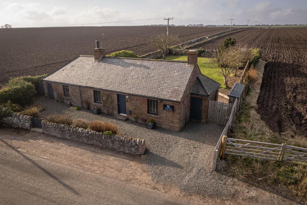 an aerial view of a house in the middle of a field at Cliff Walk Cottage in Arbroath