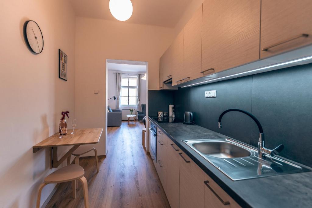 a kitchen with a sink and a counter top at Apartmány CAFÉ-CAFÉ in Jičín