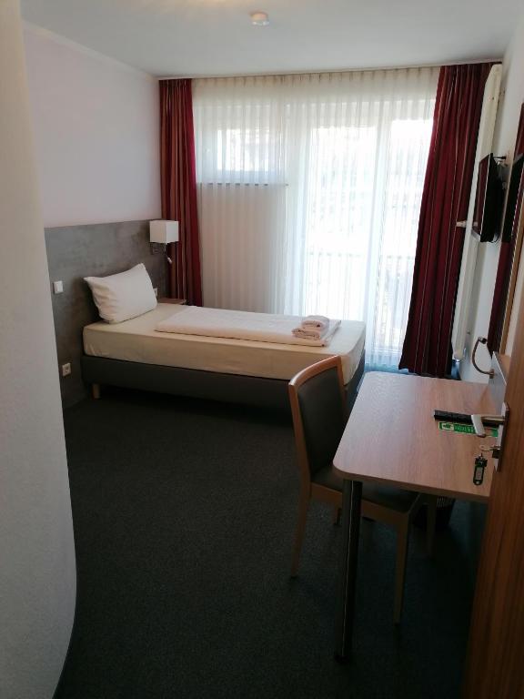 Postel nebo postele na pokoji v ubytování Hotel Lohmann