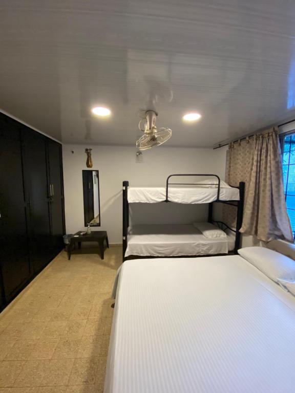 Postel nebo postele na pokoji v ubytování BOUTIQUE HOTEL BALOP Valledupar