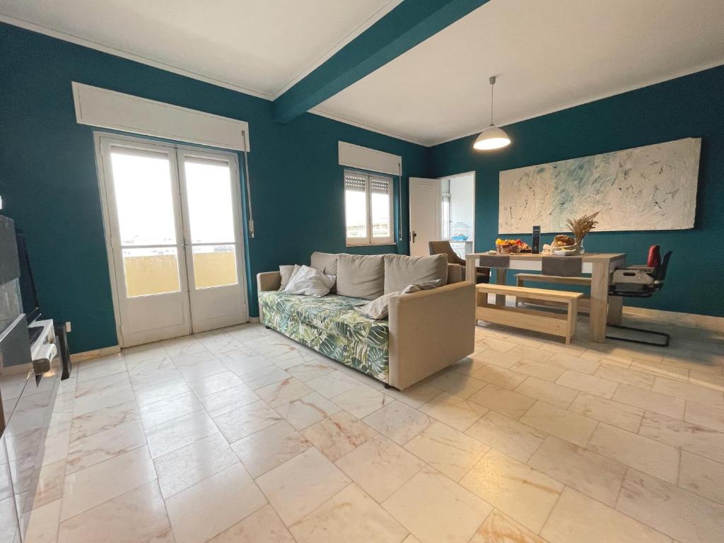 a living room with a couch and a table at Blue Bay Apartment in Setúbal