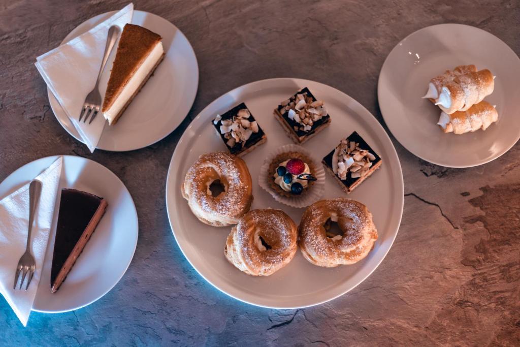 a group of plates of desserts on a table at Apartmány CAFÉ-CAFÉ in Jičín