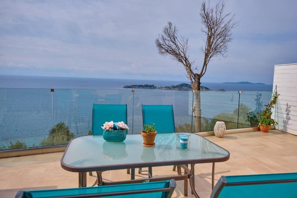 a table and chairs with a view of the water at Villa Meli Afionas Corfu in Afionas