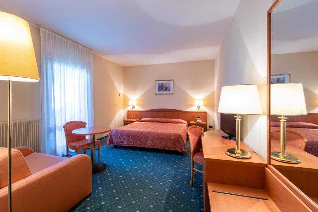 Postel nebo postele na pokoji v ubytování Hotel La Perla