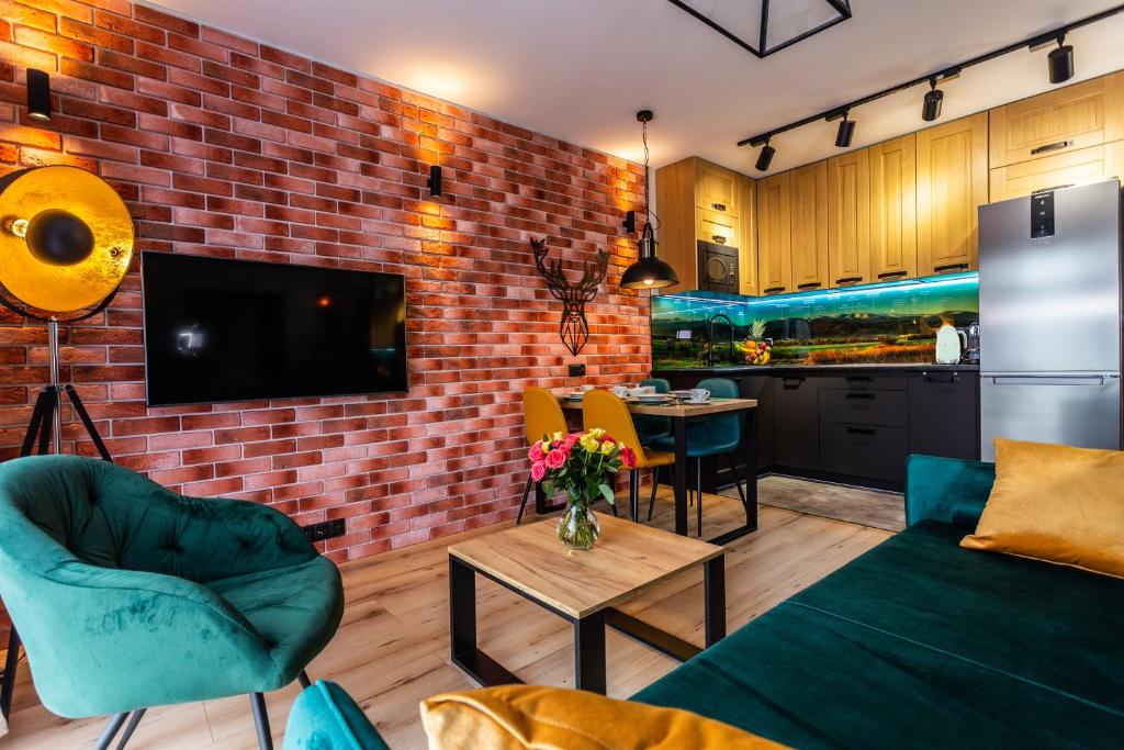 a living room with a brick wall at Apartament Jelonek in Jelenia Góra